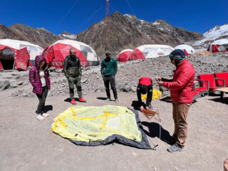 Expedition team attending a high-altitude emergency equipment briefing at Aconcagua base camp