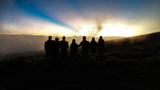 Life Happens Outdoors group watching sunrise in the mountains, representing editorial accountability and community feedback.