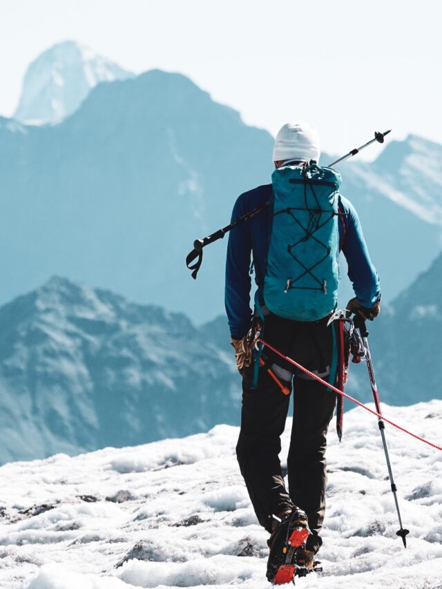 Mountaineer carrying technical equipment on a glacier, representing specialist review of high-altitude and Nepal climbing content.
