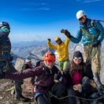 Life Happens Outdoors climbers and guides celebrating on the summit of Weissmies in the Swiss Alps