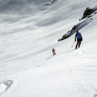 Two ski tourers ascending a snow-covered Himalayan slope during a Mera Peak expedition in Nepal