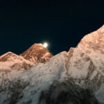 Mount Everest and Nuptse lit by sunset beneath a rising moon, viewed from Kala Patthar in Nepal