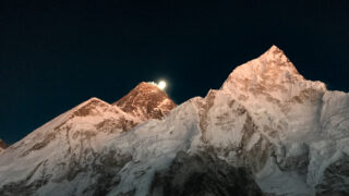 Mount Everest and Nuptse lit by sunset beneath a rising moon, viewed from Kala Patthar in Nepal