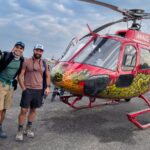 Life Happens Outdoors joiners beside a helicopter for a Lukla transfer in Nepal