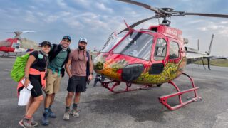 Life Happens Outdoors joiners beside a helicopter for a Lukla transfer in Nepal