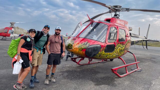Life Happens Outdoors joiners beside a helicopter for a Lukla transfer in Nepal