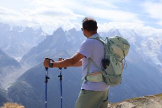 Hiker looking across the Mont Blanc massif on a sunny Tour du Mont Blanc stage